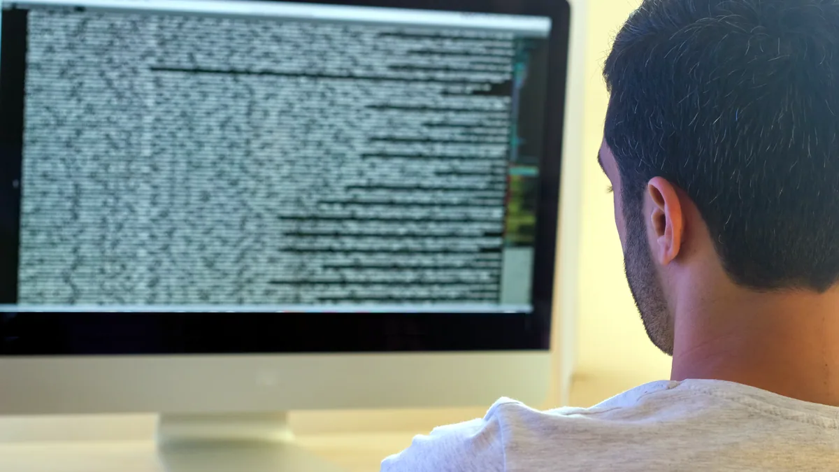 A monitor displaying dense C source code from a kernel build directory.