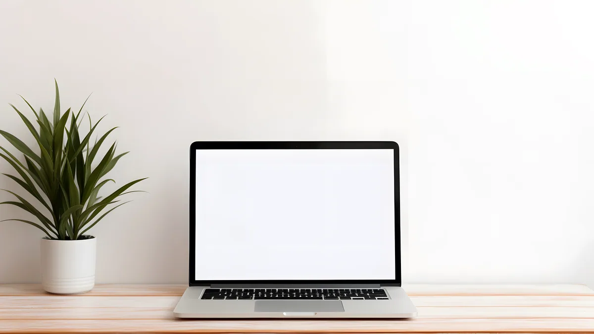 A lightweight netbook laptop on a small desk with a simple Linux desktop.