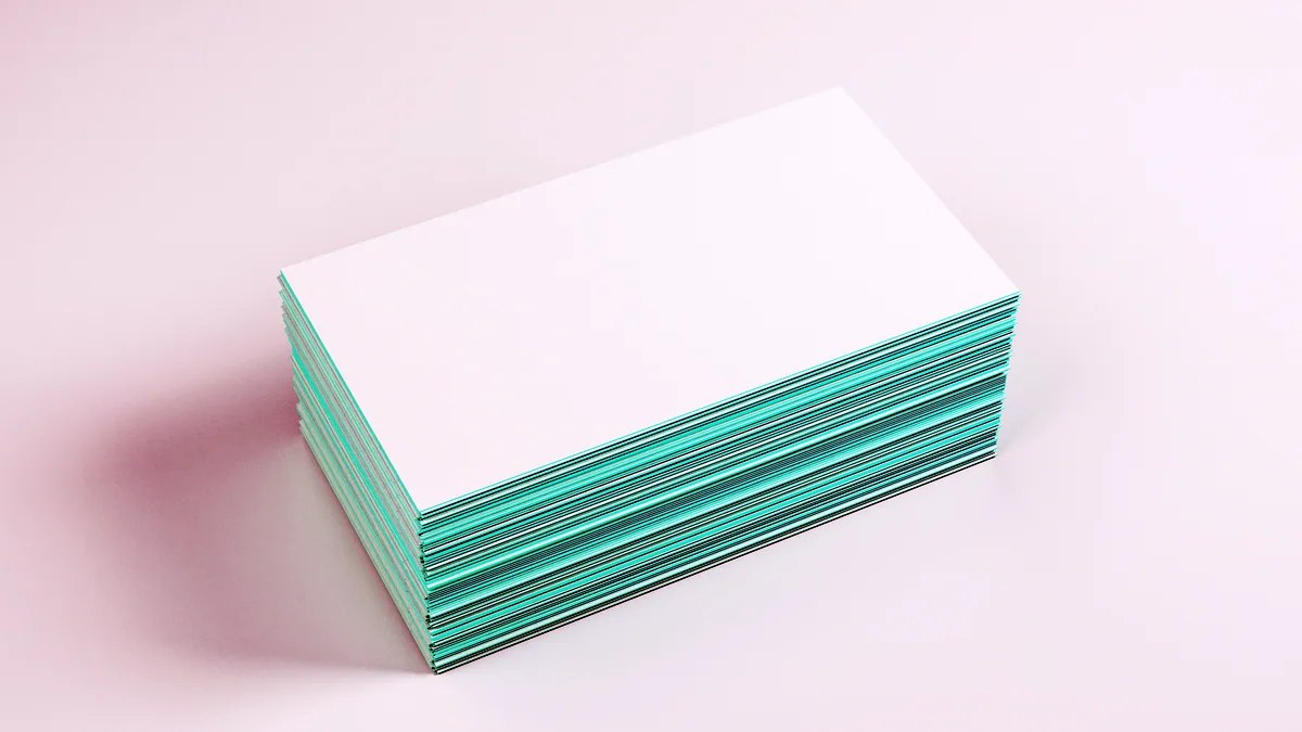 A stack of index cards where some empty fields are filled in with pen.