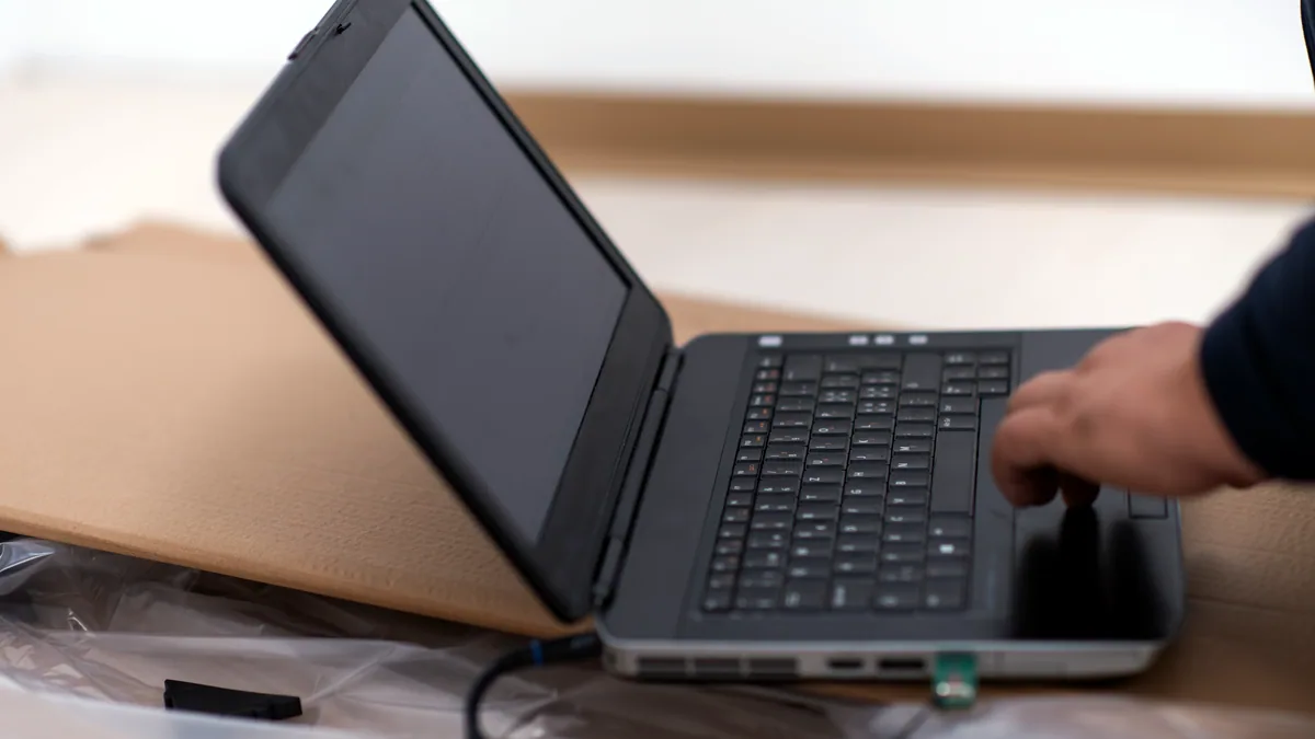 A laptop screen showing a package manager installing database software.